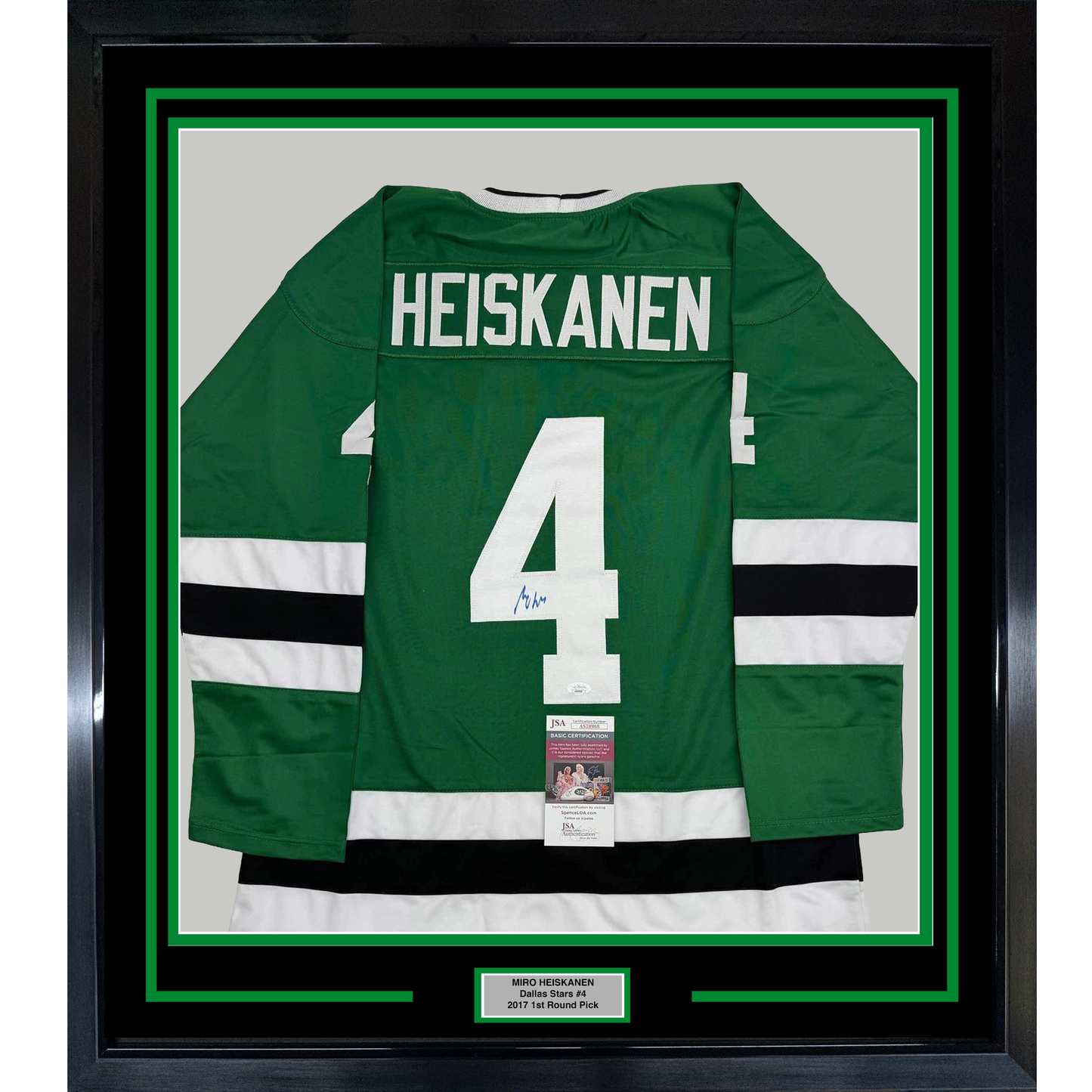 Framed green Dallas Stars hockey jersey number 4 with "HEISKANEN" nameplate, white and black stripes, displayed against white matting with JSA authentication certificate visible.