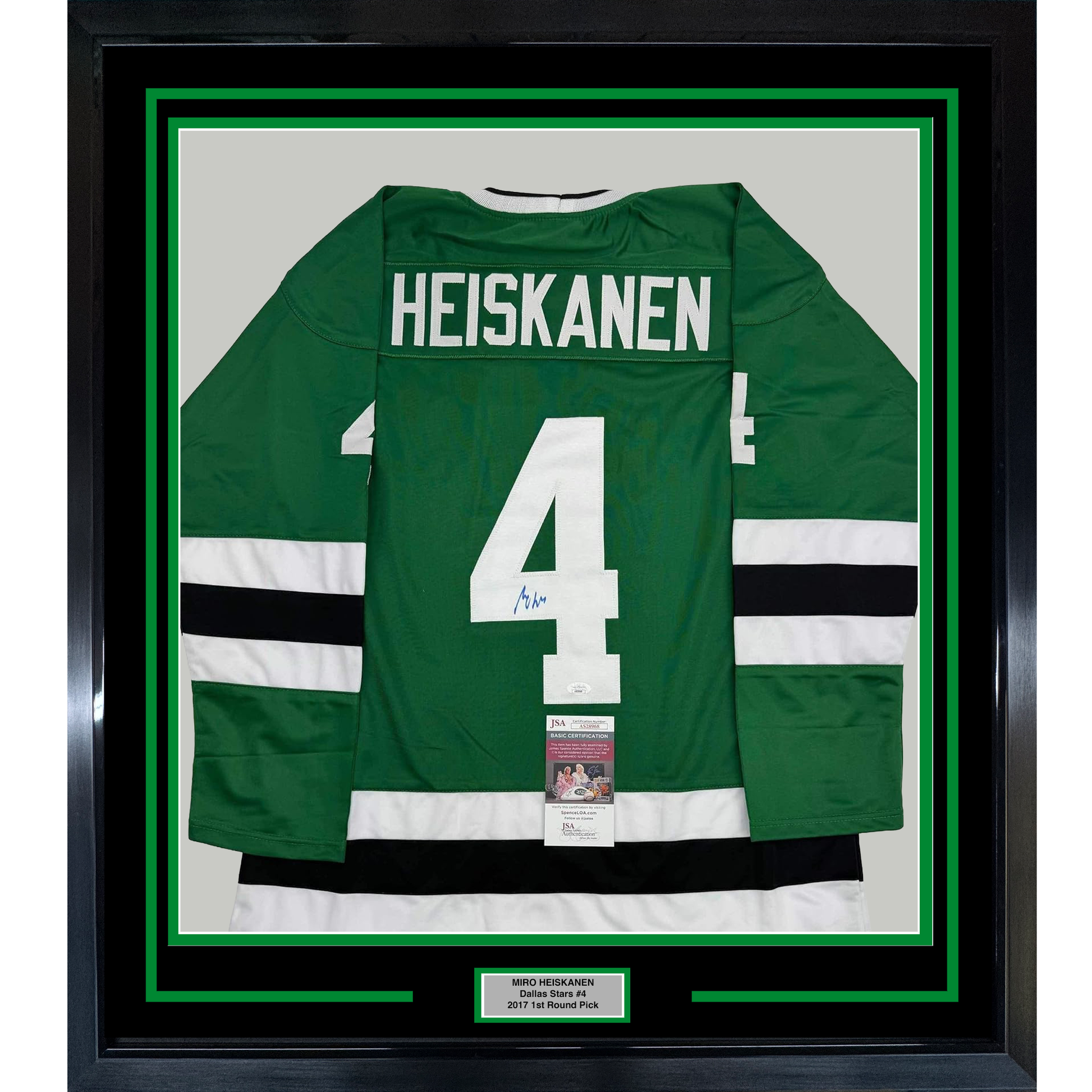 Framed green Dallas Stars hockey jersey number 4 with "HEISKANEN" nameplate, white and black stripes, displayed against white matting with JSA authentication certificate visible.