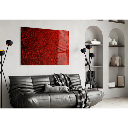 Vibrant red textured 3D glass wall art with raised rose patterns above black sofa