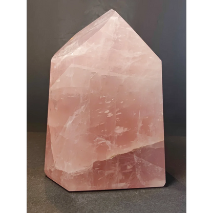 Rose quartz polished obelisk tower sculpture with translucent pink faceted geometric design for decor or healing