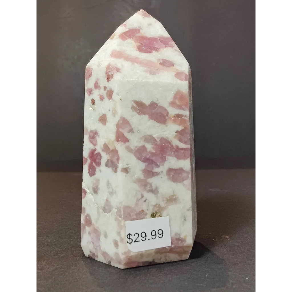 A pink and white speckled rose quartz polished obelisk tower sculpture featuring rubellite in quartz