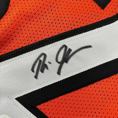 Orange mesh Bengals sports jersey with black and white stripe and Rudi Johnson autograph
