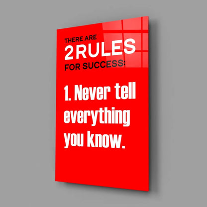 Vibrant red glass wall art with bold white text: there are 2 rules for success 1
