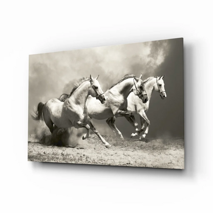 Black and white canvas wall art of three horses galloping in dusty field