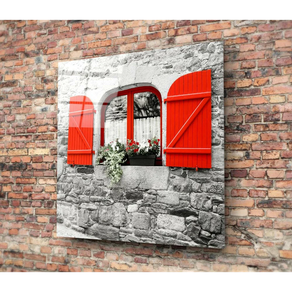 Rustic red shutters with floral box wall art on stone wall
