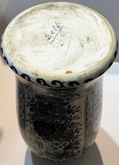 Base of the Delft-style vase turned up: a hand-written Delft mark with a slash and small marks on the unglazed foot, blue scroll border at the rim.