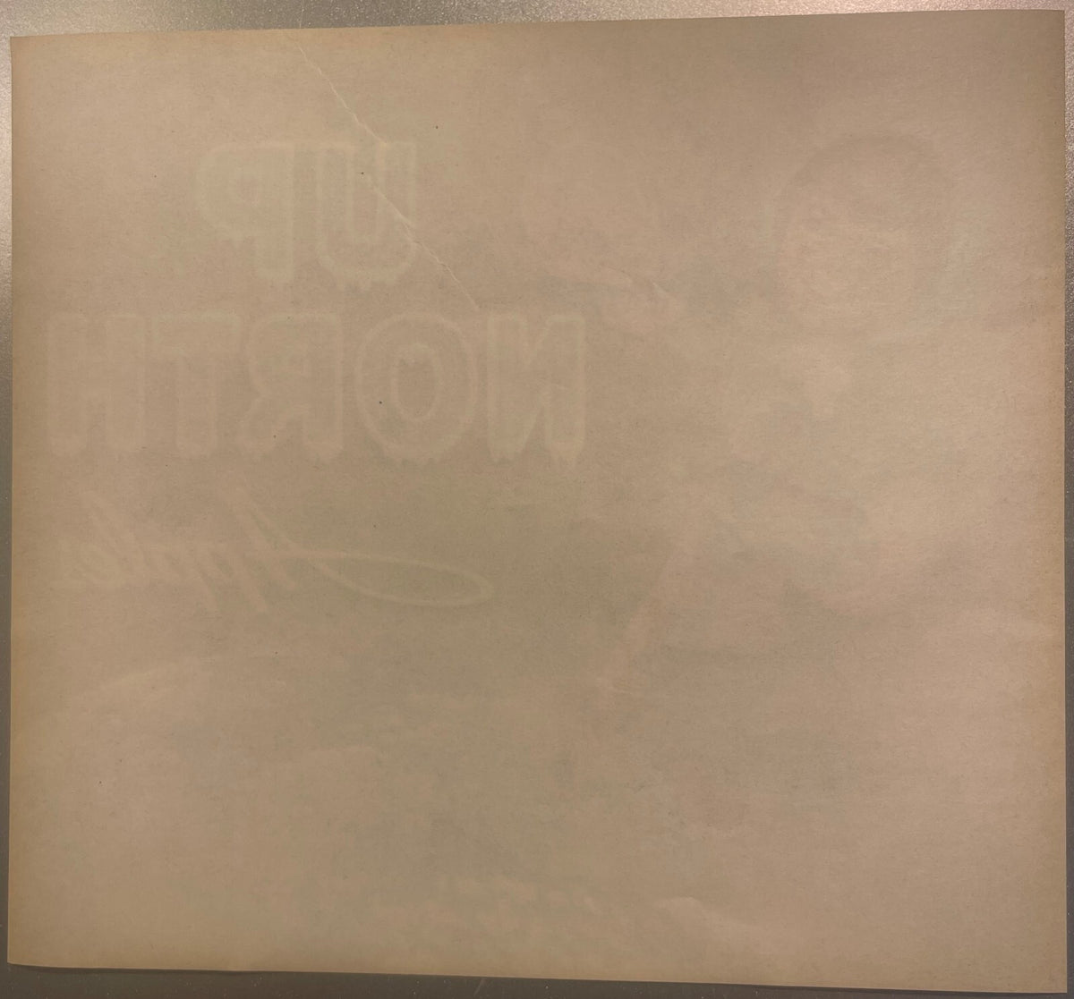 Back of the Up North crate label: plain toned paper with the Up North lettering and the picture showing faintly through in reverse