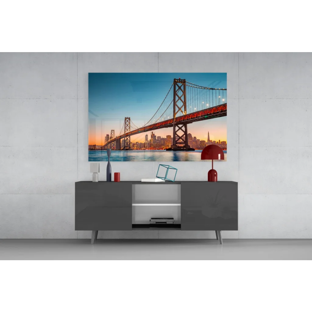 Vibrant red lamp on gray console with San Francisco Bay Bridge sunset wall art