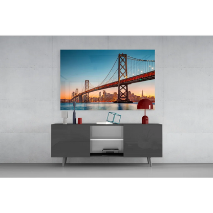 Vibrant red lamp on gray console with San Francisco Bay Bridge sunset wall art
