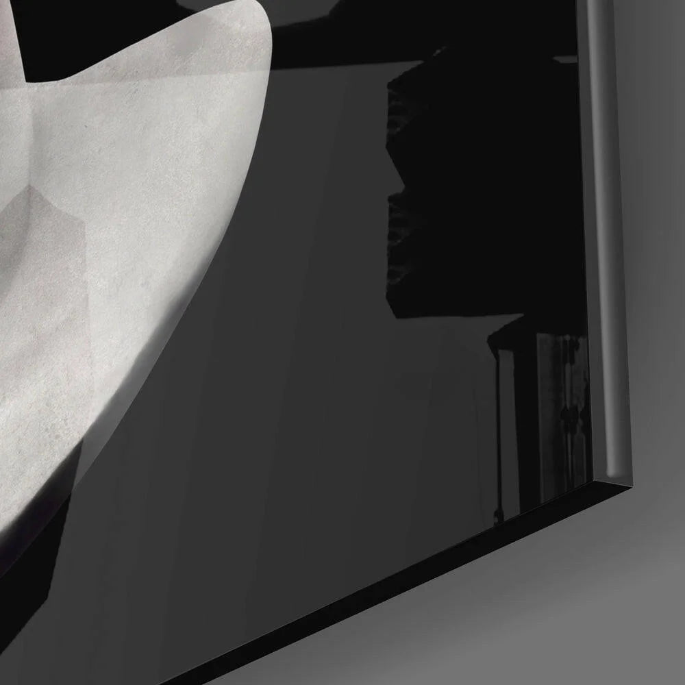 Sleek black-framed glass wall art with surreal marble bust and spiral void design