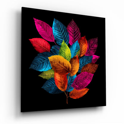 Colorful illuminated leaves in magenta, blue, yellow, and orange arranged in a circular pattern on black glass, displayed at an angle showing the three-dimensional panel.