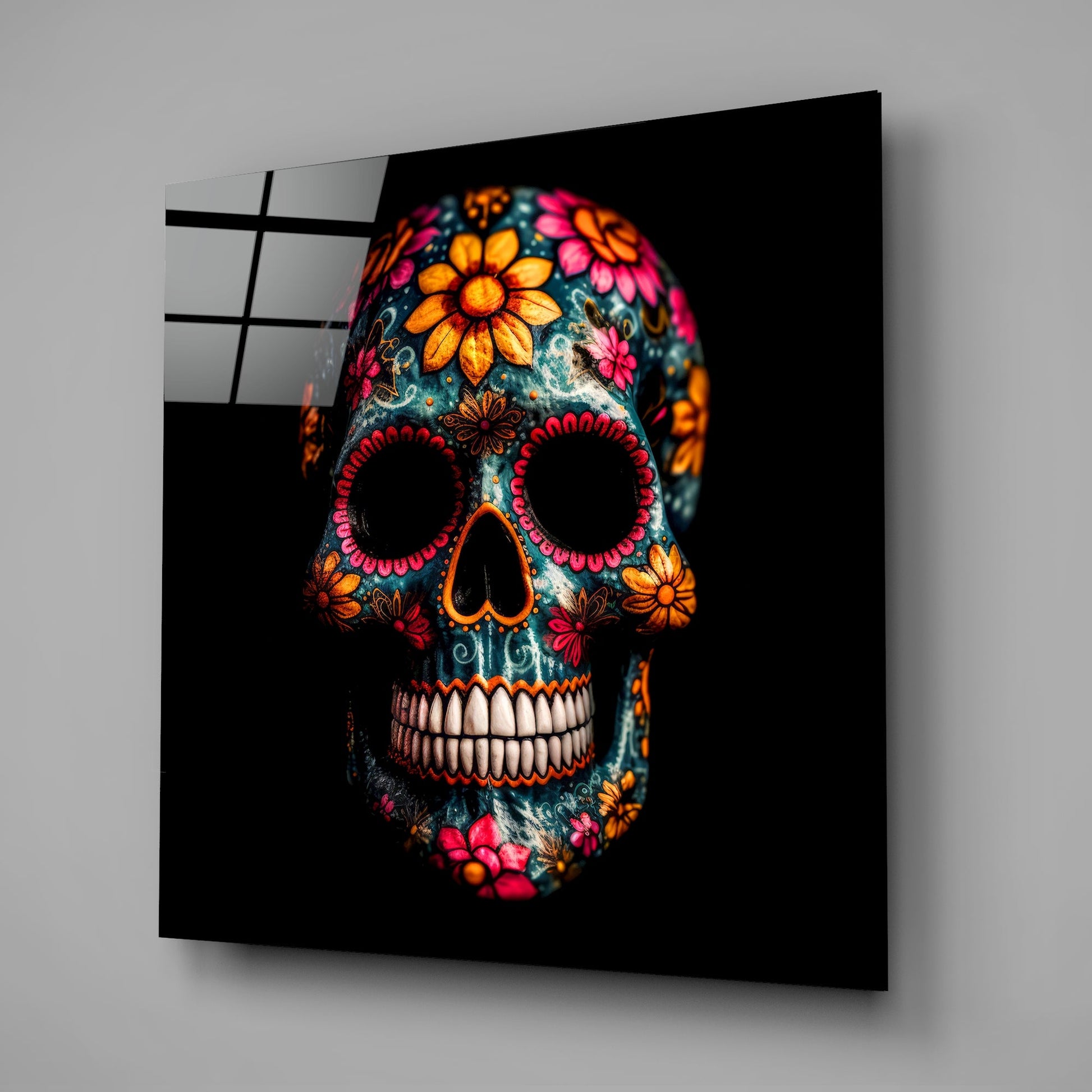 Angled perspective of decorative glass wall art displaying a colorful skull with vibrant orange, pink, and red floral patterns against black background.