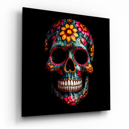 Colorful decorated skull with orange, pink, and red flowers on dark teal background, displayed at three-quarter angle against black.