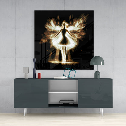 Flame Dancer Glass Wall Art displayed above a gray media console with decorative items and a lamp in a modern interior setting.
