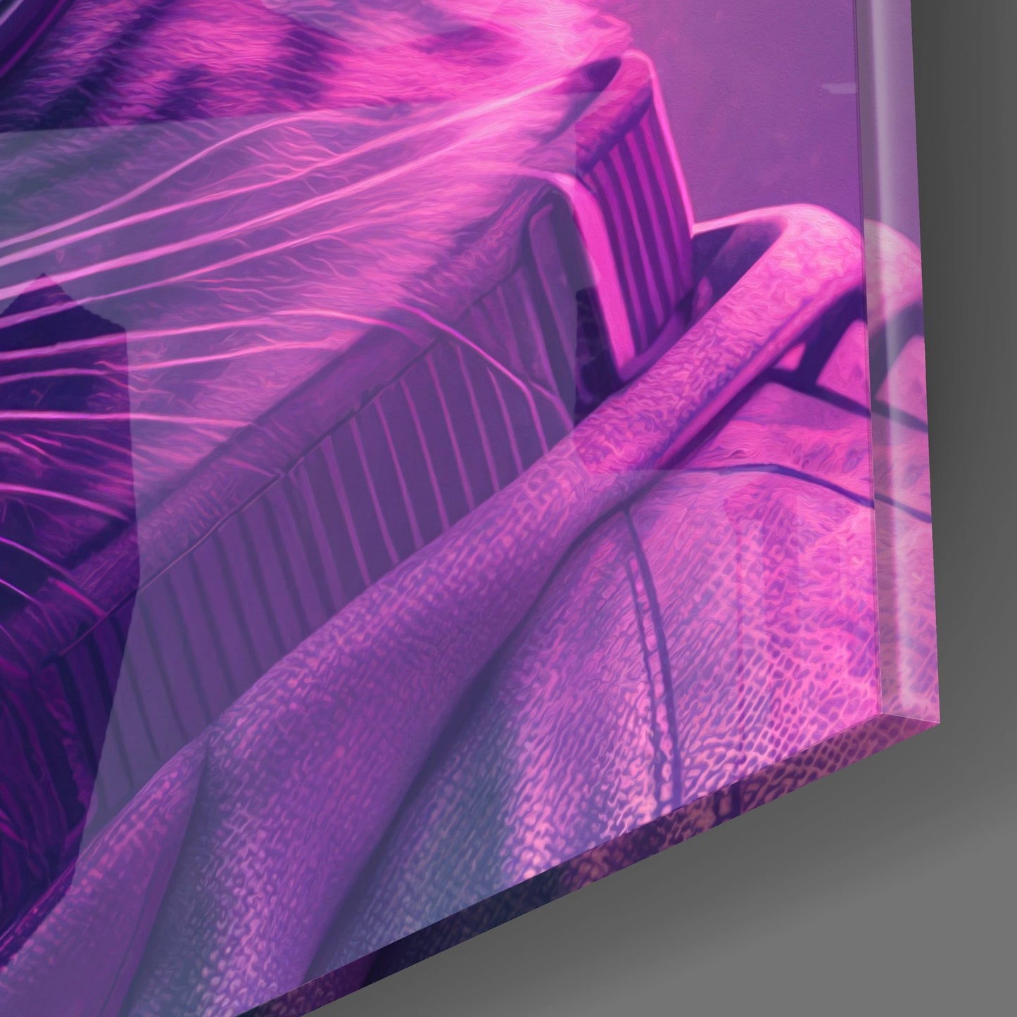 Close-up angled view of magenta neon-lit glass wall art with striped feline features and flowing hair details against gray background.