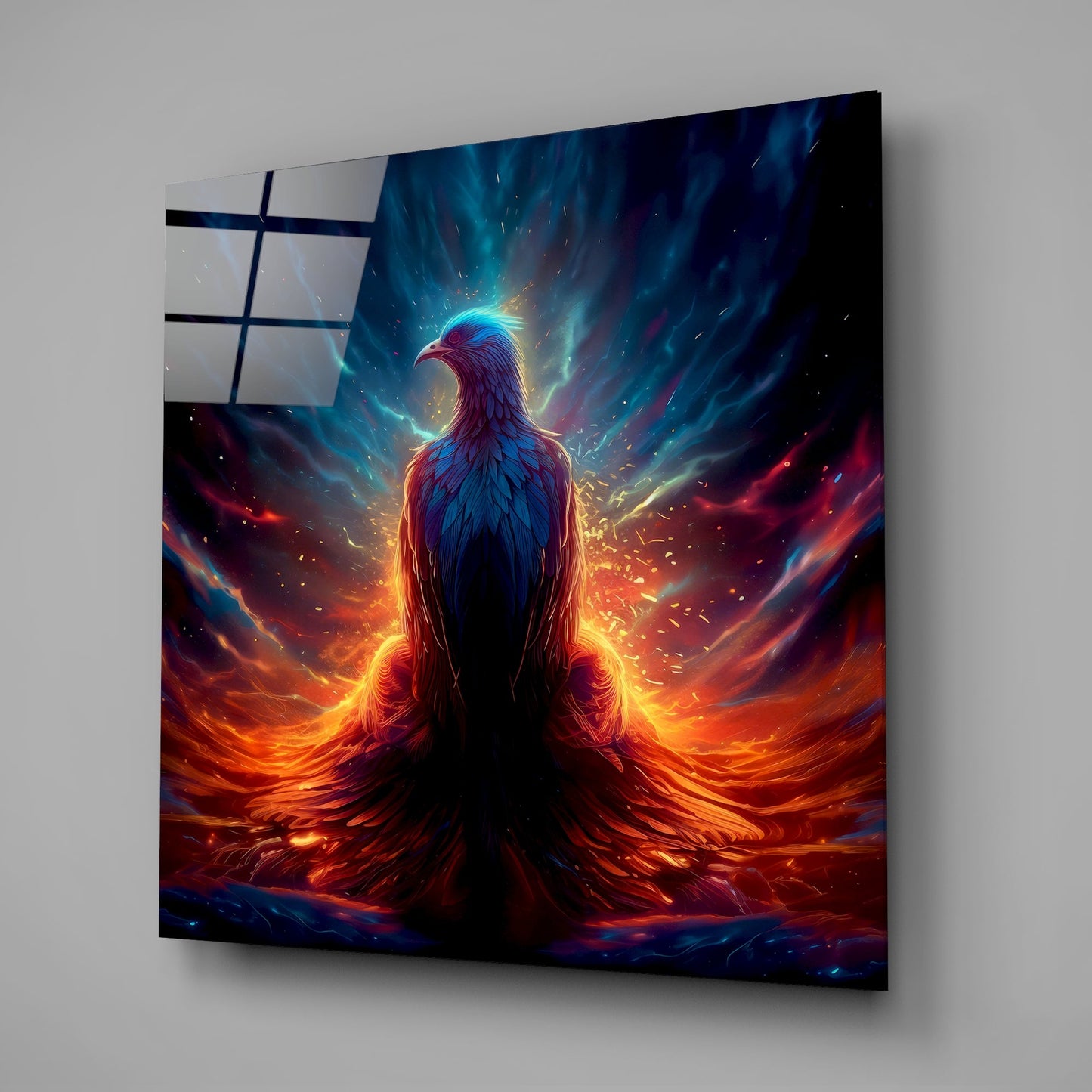Angled view of glass wall art featuring a glowing phoenix with blue head and fiery orange-red wings against a dark background.