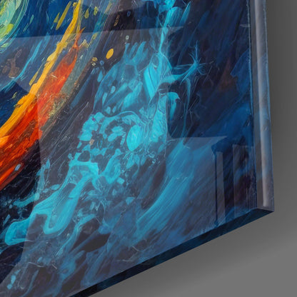 Close-up angled view of glass wall art showing vibrant blue, cyan, red, and yellow swirling abstract patterns with metallic edge detail.