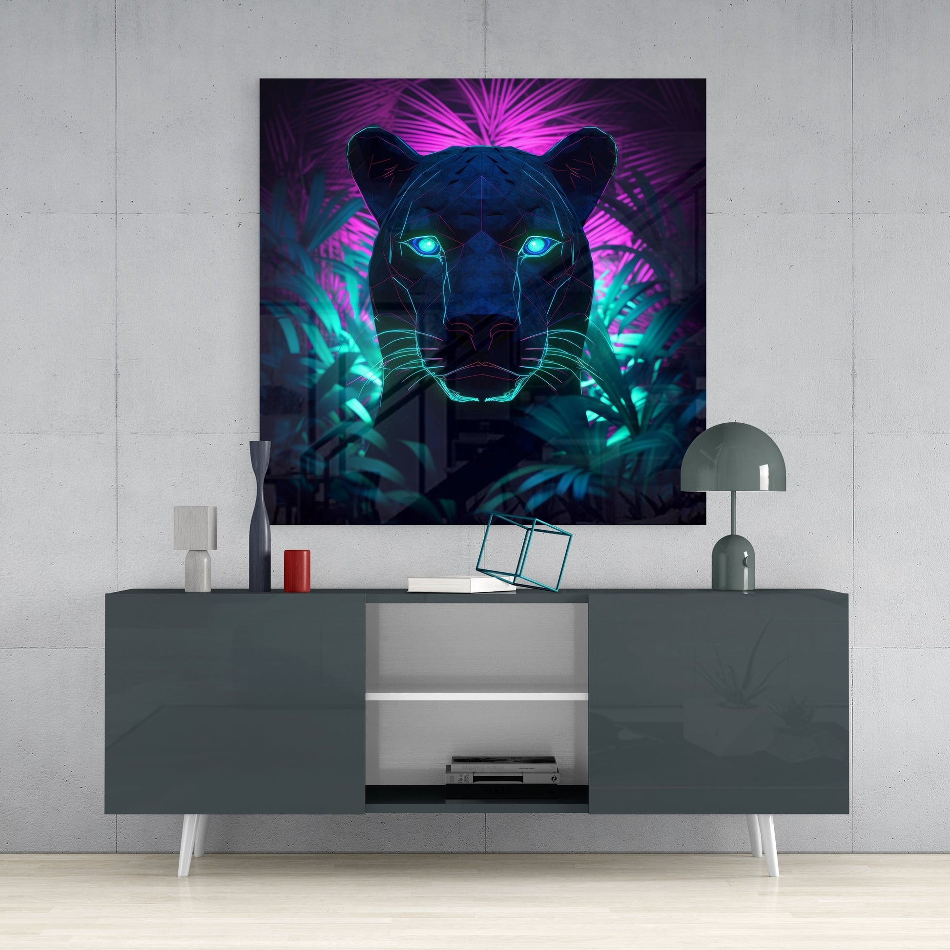 Neon panther glass wall art with glowing cyan eyes and magenta-green neon lines displayed above gray media console in modern interior setting.