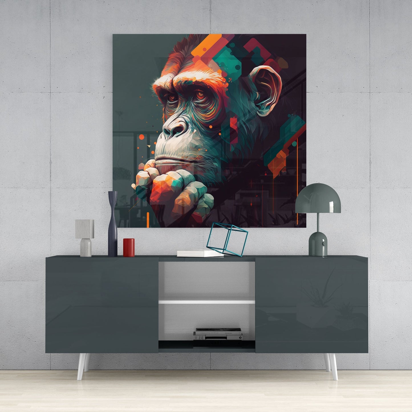 Colorful glass wall art of a contemplative chimpanzee with orange, teal, and red tones displayed above a dark gray media console in a modern interior setting.