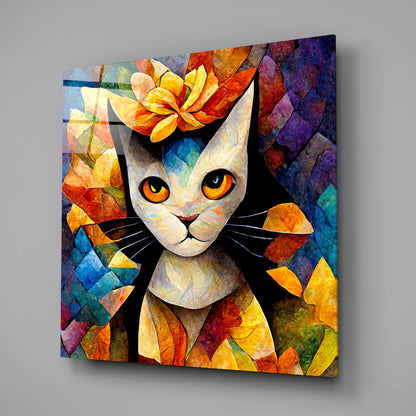 Colorful glass wall art featuring a white cat with orange eyes surrounded by vibrant multicolored flower petals and geometric patterns, displayed at an angle.