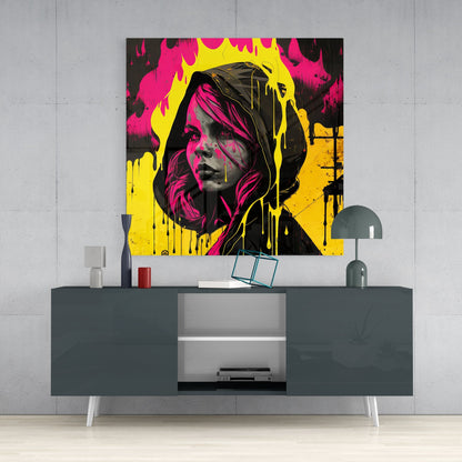 Vibrant pop art glass wall panel featuring a hooded woman's face in magenta, yellow, and black displayed above a dark gray media console.