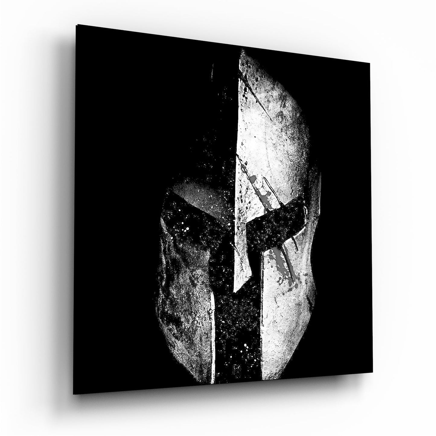 Black and white glass wall art depicting a split Spartan helmet design with white textured surface against dark background.