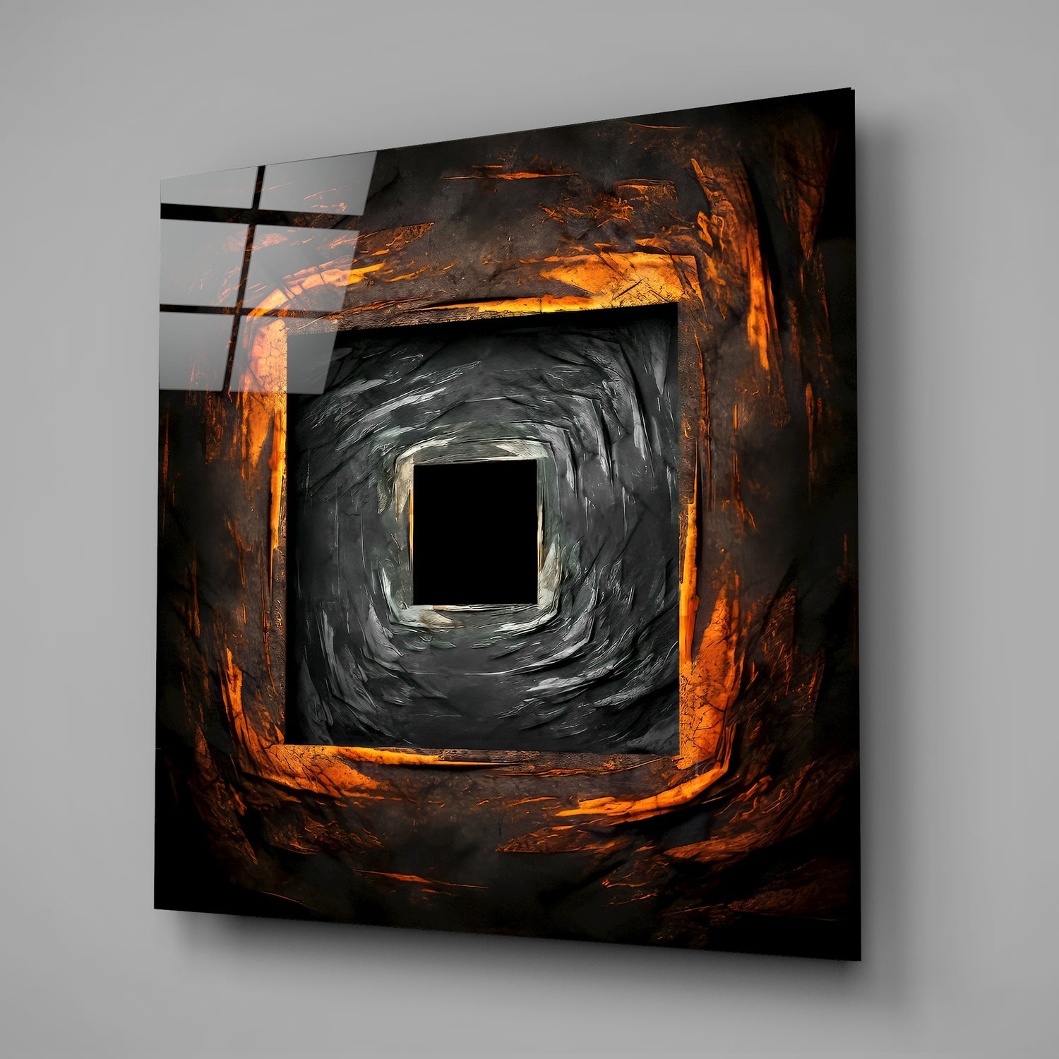 Square glass wall art with concentric square frames featuring orange and black brushstroke textures, mounted on gray wall.