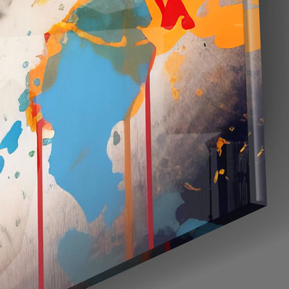Angled side view of colorful glass wall art featuring profile silhouettes, blue water, orange and red accents against white background.