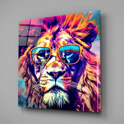 Colorful glass wall art featuring a lion wearing sunglasses with vibrant neon pink, yellow, and blue hues displayed at an angle.