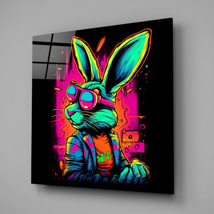 Neon-colored retro rabbit wearing sunglasses and colorful jacket displayed on black glass wall art, angled perspective view.