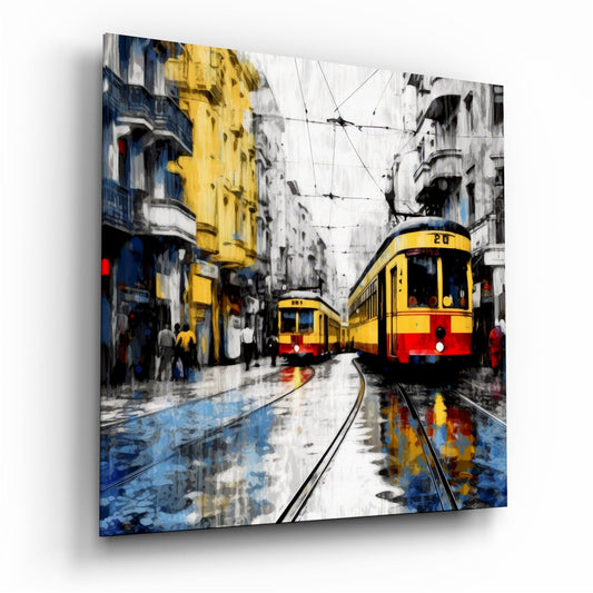 Yellow and red trams on wet tracks in a European city street with colorful buildings and overhead wires, displayed as glass wall art.