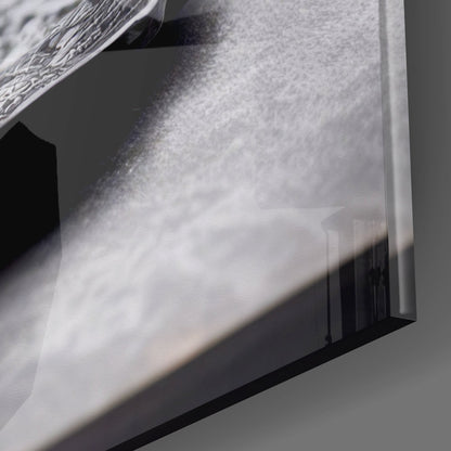 Close-up detail of textured glass surface with water droplets and shadow casting across frosted white panel.