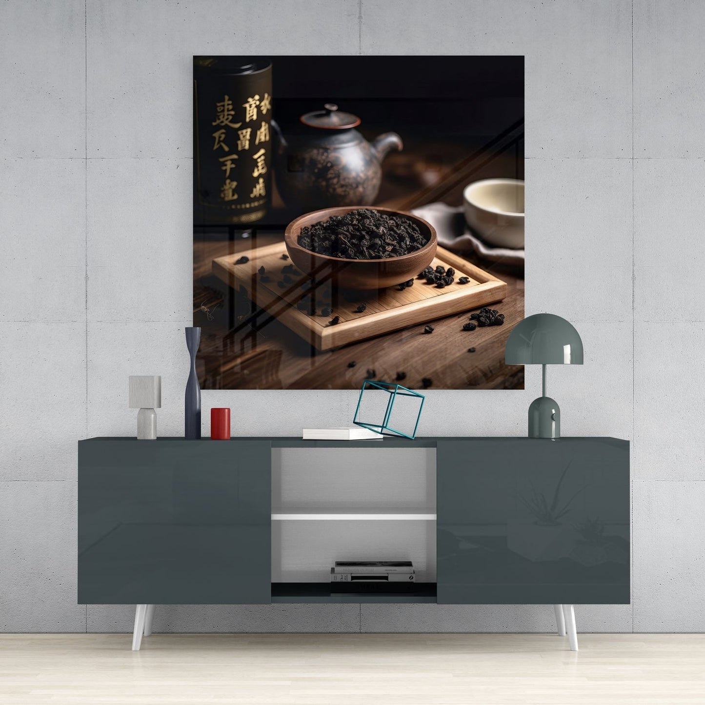 Tea Party Glass Wall Art displayed above a gray media console, showing dried tea leaves in a wooden bowl with Asian pottery and calligraphy bottle.