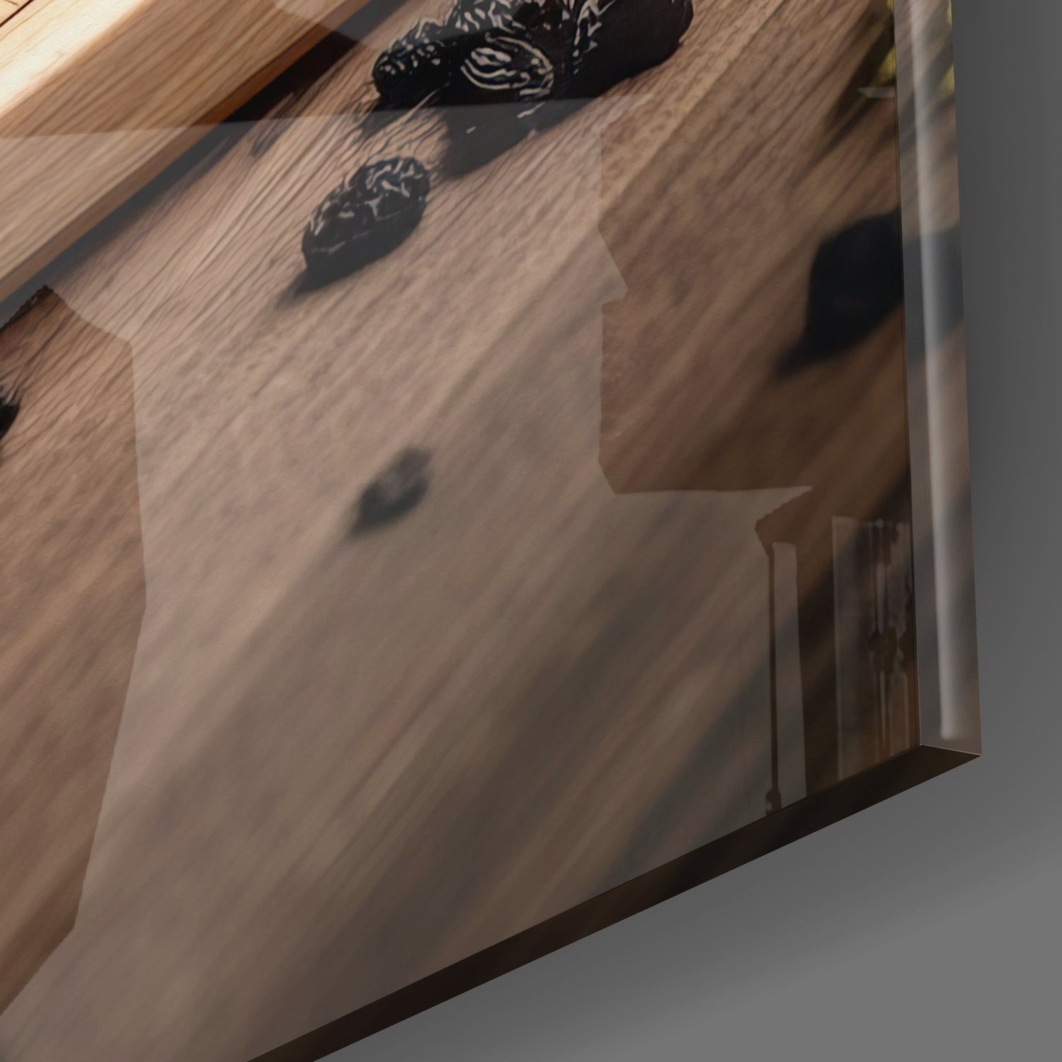 Tea Party Glass Wall Art mounted on wooden wall, angled view showing black silhouette designs and shadow cast by sunlight.