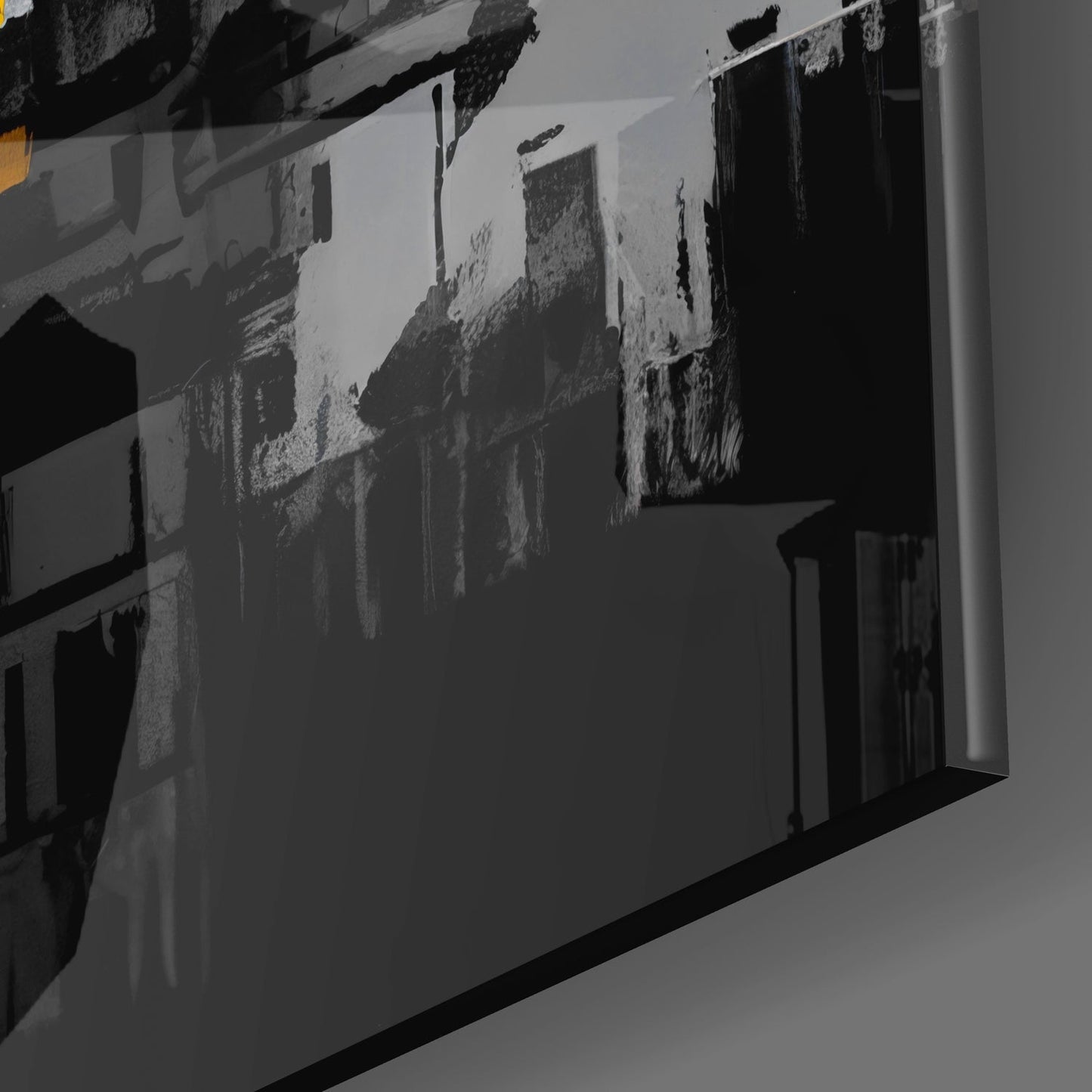 Glass wall art panel displaying black and white cityscape photograph mounted at an angle, showing architectural details and urban buildings.