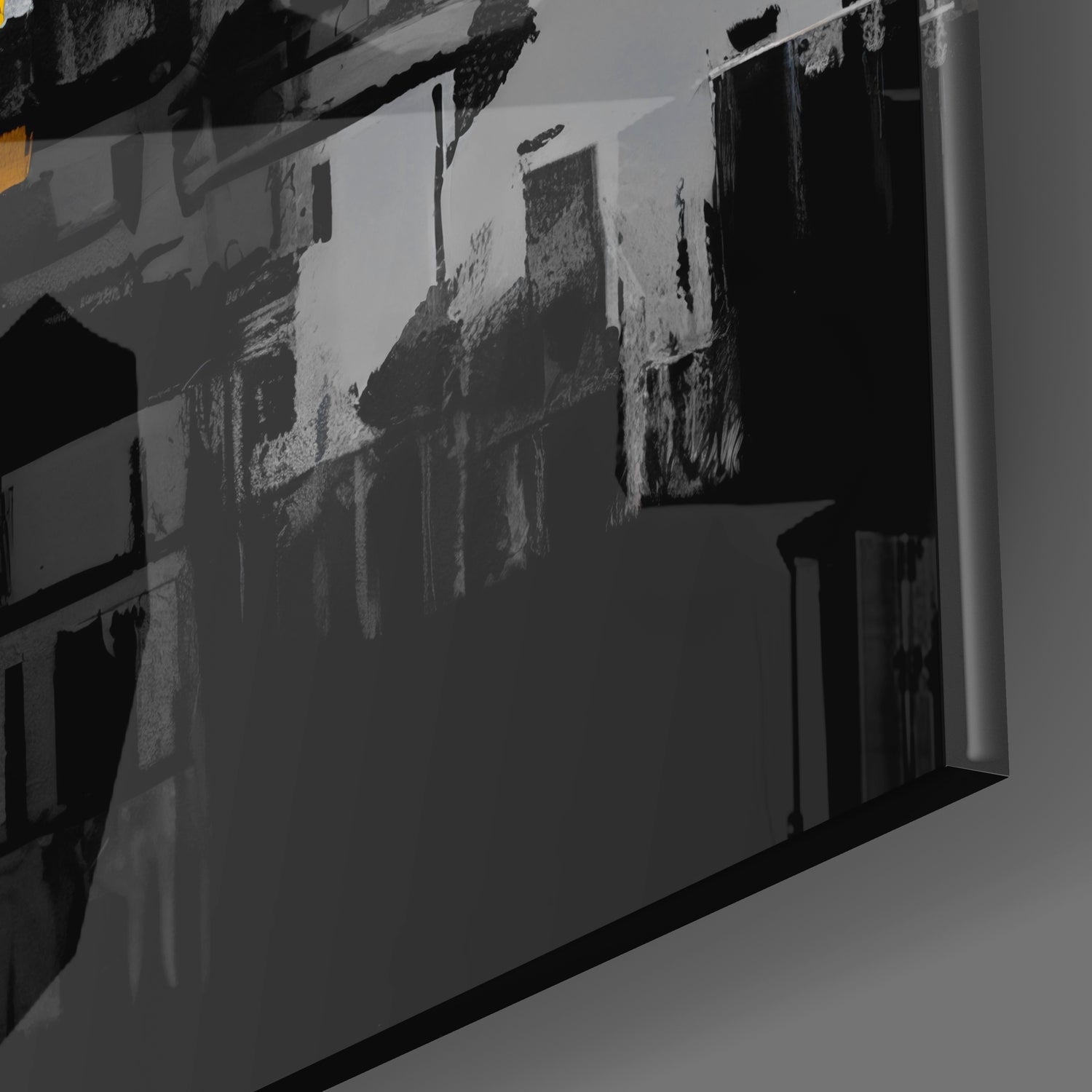 Glass wall art panel displaying black and white cityscape photograph mounted at an angle, showing architectural details and urban buildings.
