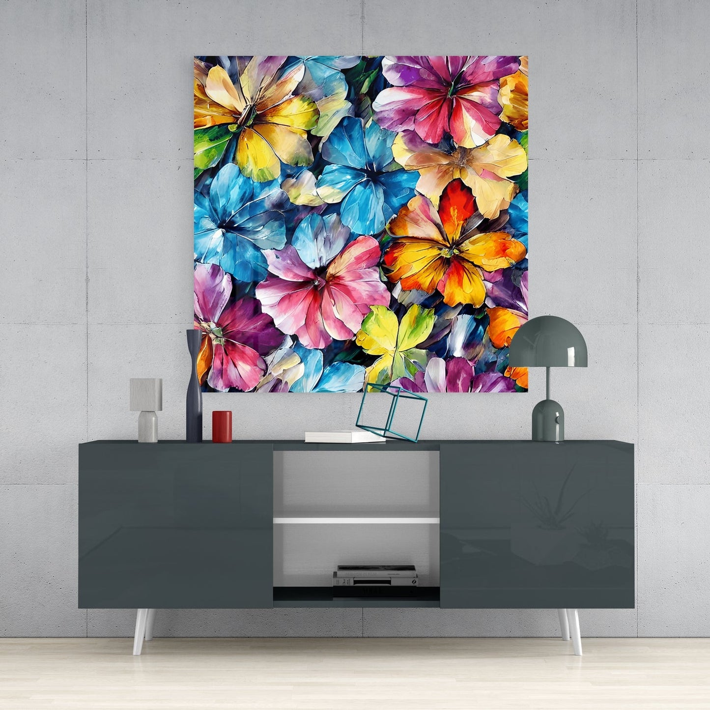 Colorful floral glass wall art featuring overlapping painted flowers in blue, pink, yellow, and purple displayed above a dark gray media console.