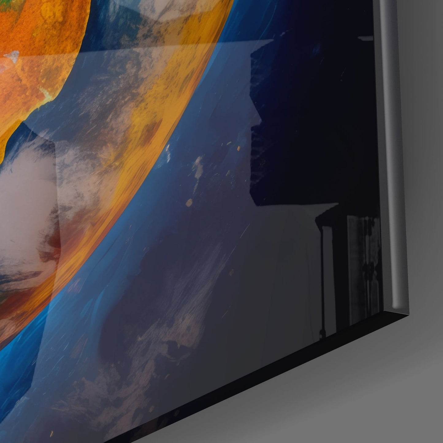 Close-up angled view of glass wall art showing orange, blue, and white abstract painted design with black frame edge visible.