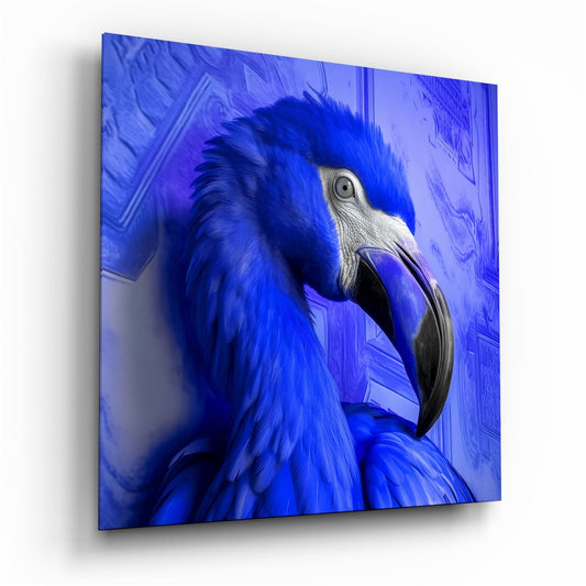 Close-up side profile of a blue macaw with white facial markings on blue glass panel, displayed at angle.