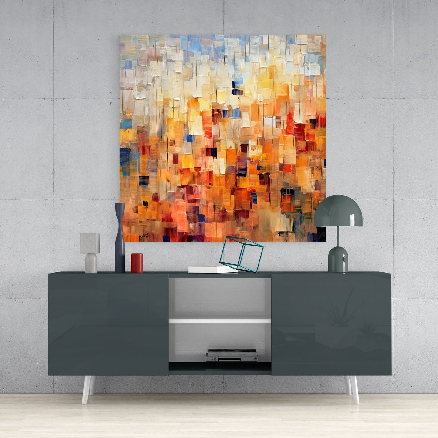 Modern living room interior with abstract glass wall art featuring warm orange, yellow, and blue mosaic squares displayed above a dark gray media console.