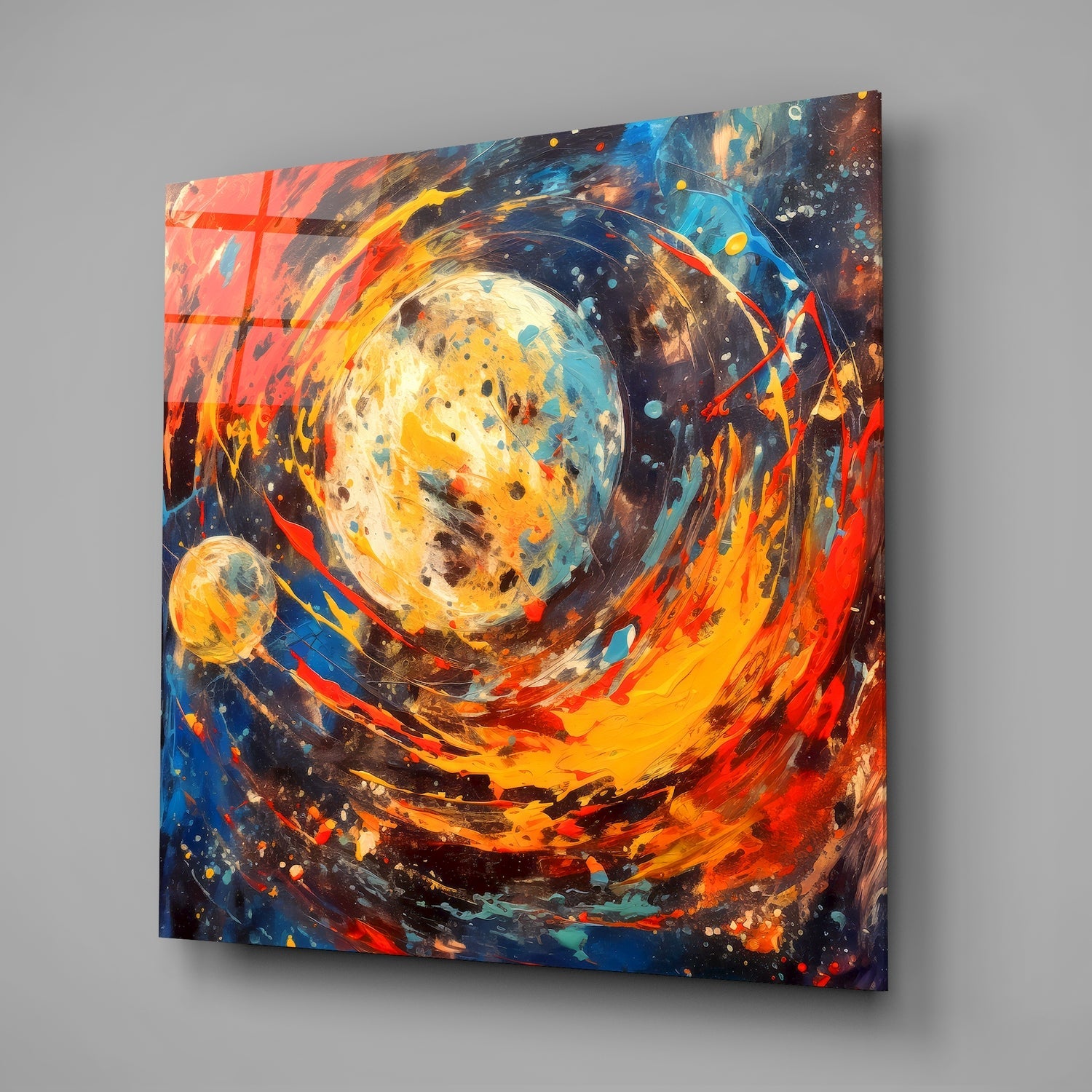 Angled view of glass wall art featuring a luminous celestial sphere surrounded by swirling orange, red, yellow, and blue brushstrokes with splattered accents.