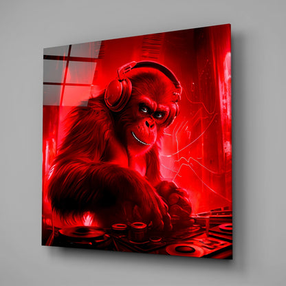 Red neon glowing glass wall art displaying a stylized chimpanzee wearing headphones at a DJ turntable, angled perspective view.