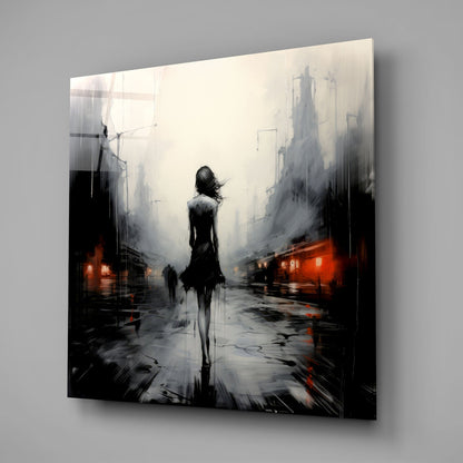 A glass wall art panel displaying a solitary silhouetted figure standing in a misty urban street with red lights and towering buildings.