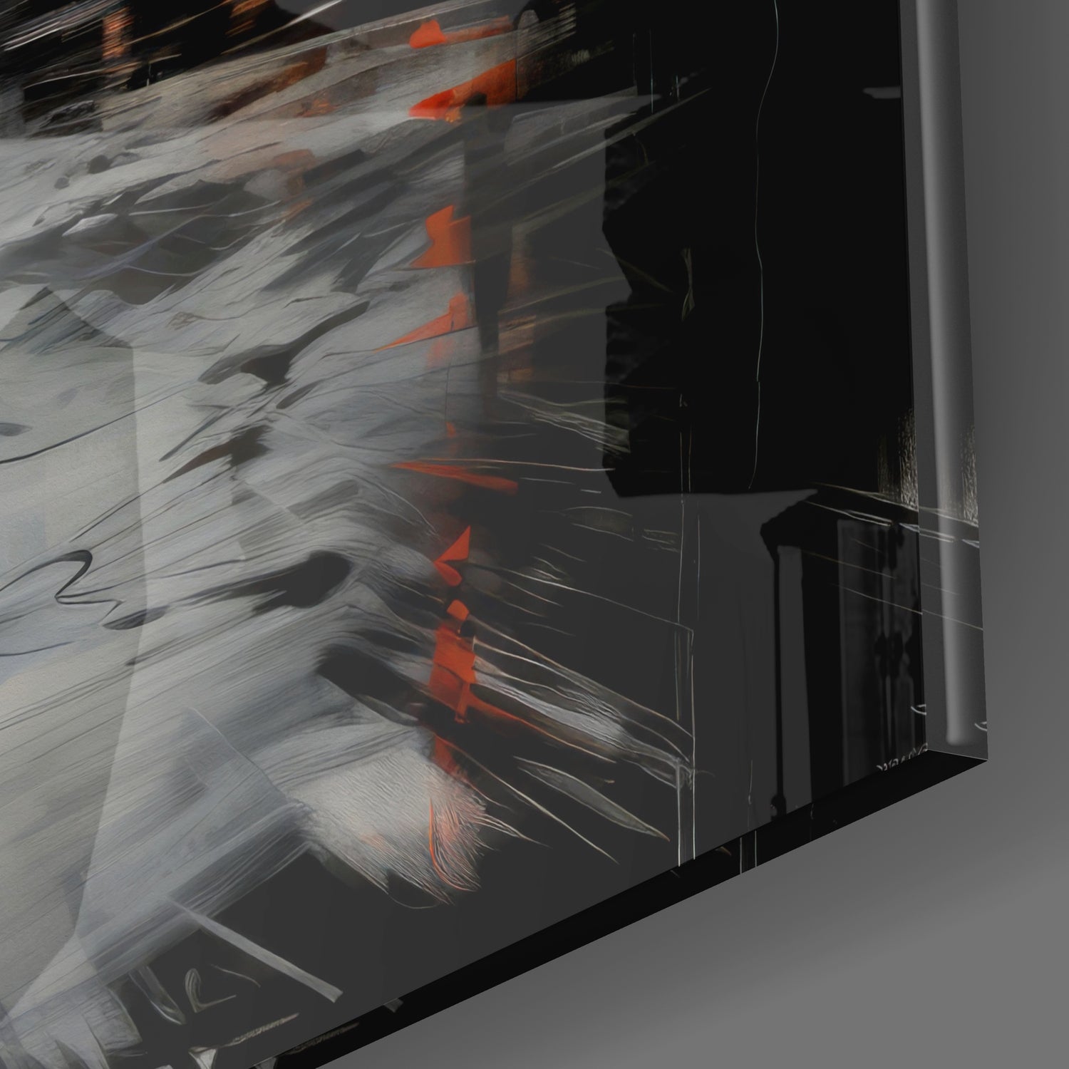 Angled view of glass wall art displaying abstract brushstroke design in gray, black, and orange tones.