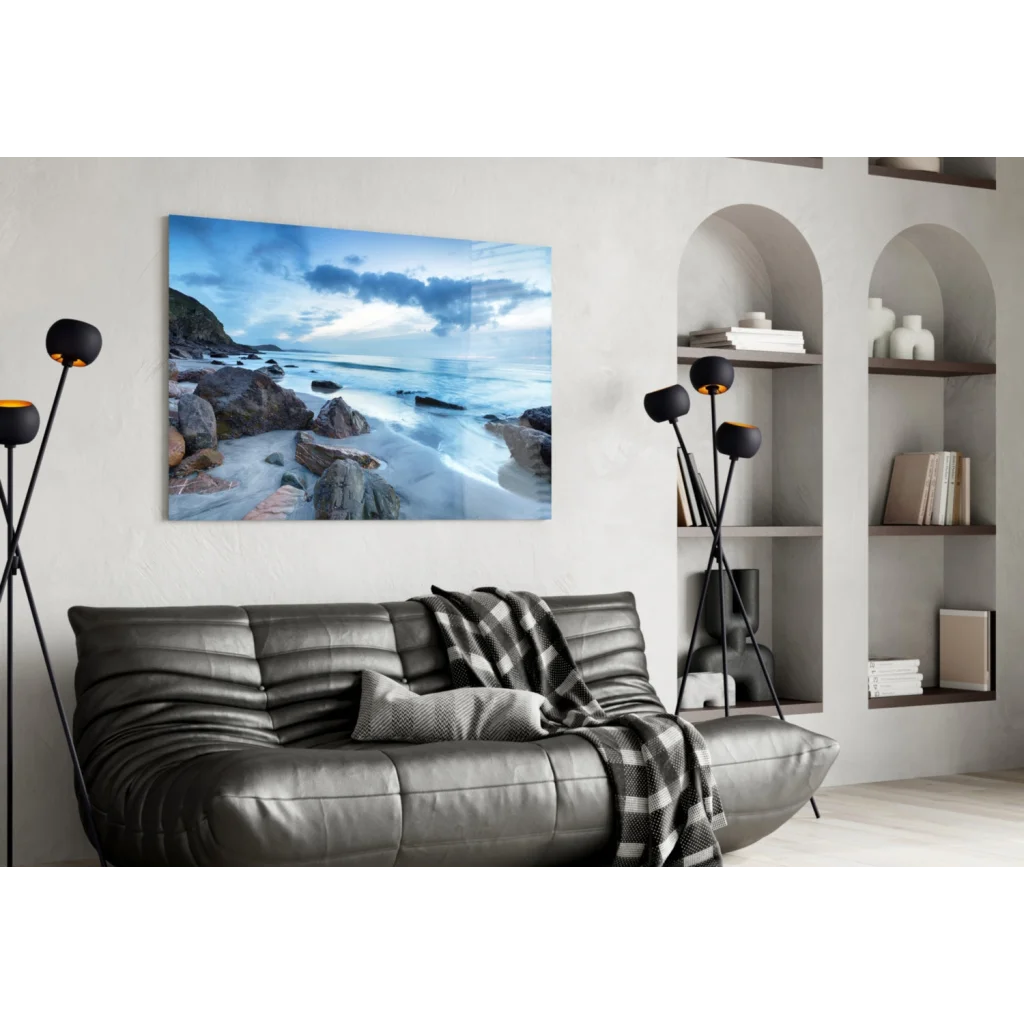 Gray ribbed leather sofa with checkered throw and blue coastal glass wall art