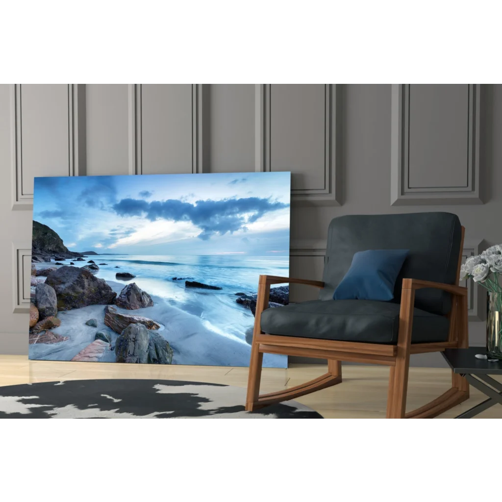 Stunning blue coastal glass wall art leaning on gray paneled wall