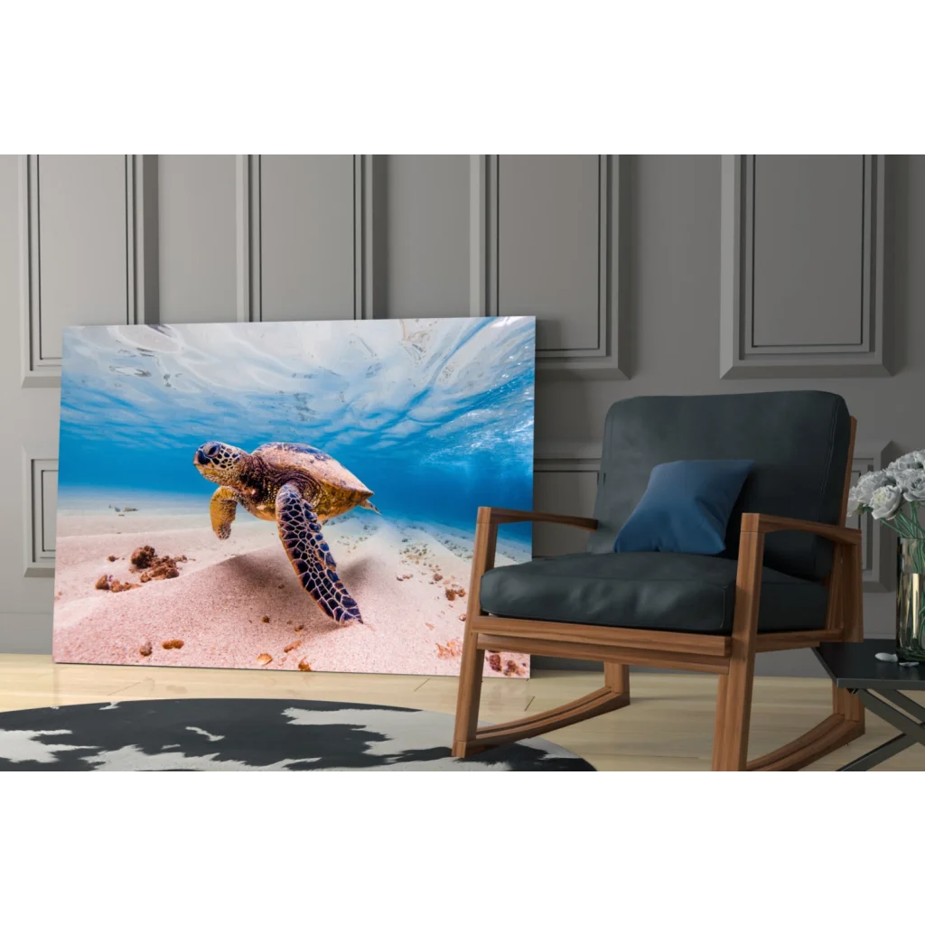 Vibrant glass wall art of sea turtle over pink sand and blue water