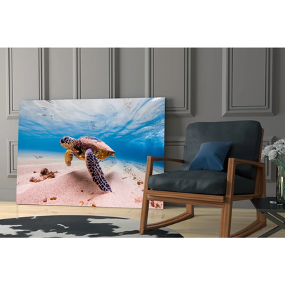 Vibrant glass wall art of sea turtle over pink sand and blue water