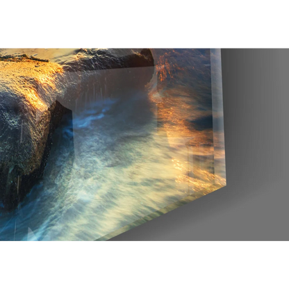 Glossy glass wall art of sunset ocean waves with golden sky on turquoise water