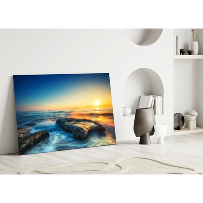 Vibrant sunset ocean waves glass wall art with golden sky and textured rocks